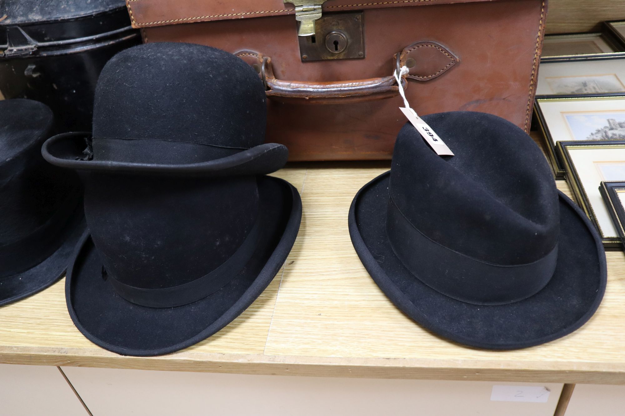 A solar pith helmet in japanned metal case, a military cap, a leather dressing case and seven other gentlemens hats, 9